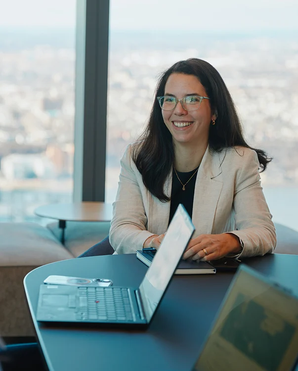 A woman sitting at a table with a laptop