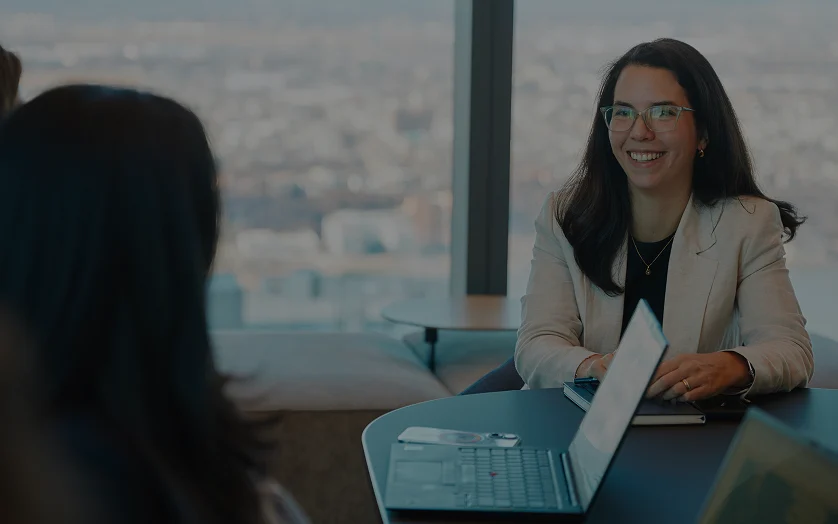 Three women sitting at a boardroom table