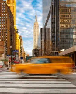 A yellow taxi driving through New York City