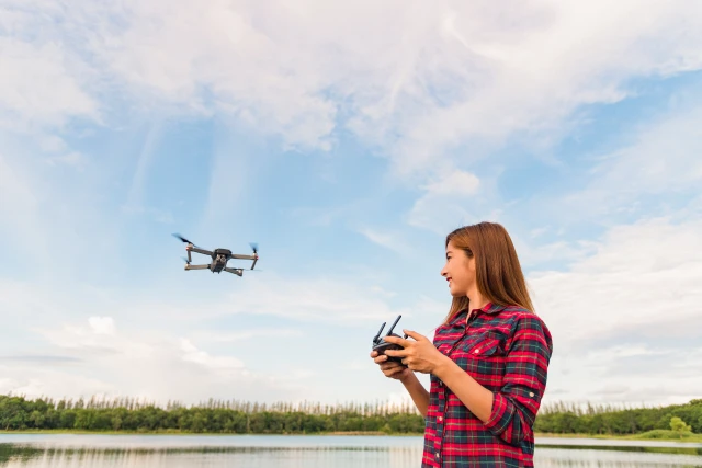 photo-portrait-asian-woman-is-operating-the-drone-by-remote-control-in-the-park-woman-is-playing-with