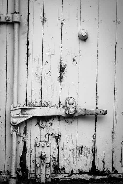 Photograph of old hinges on shed door.