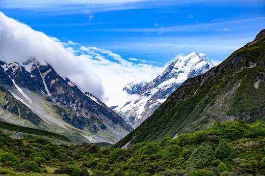 Photograph of Aoraki/Mount Cook in the distance beyond foreground mountains.