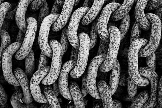Photograph of heavily corroded chain links.