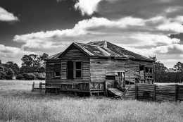 Black & White photograph of derelict weatherboard cottage in regional Victoria.