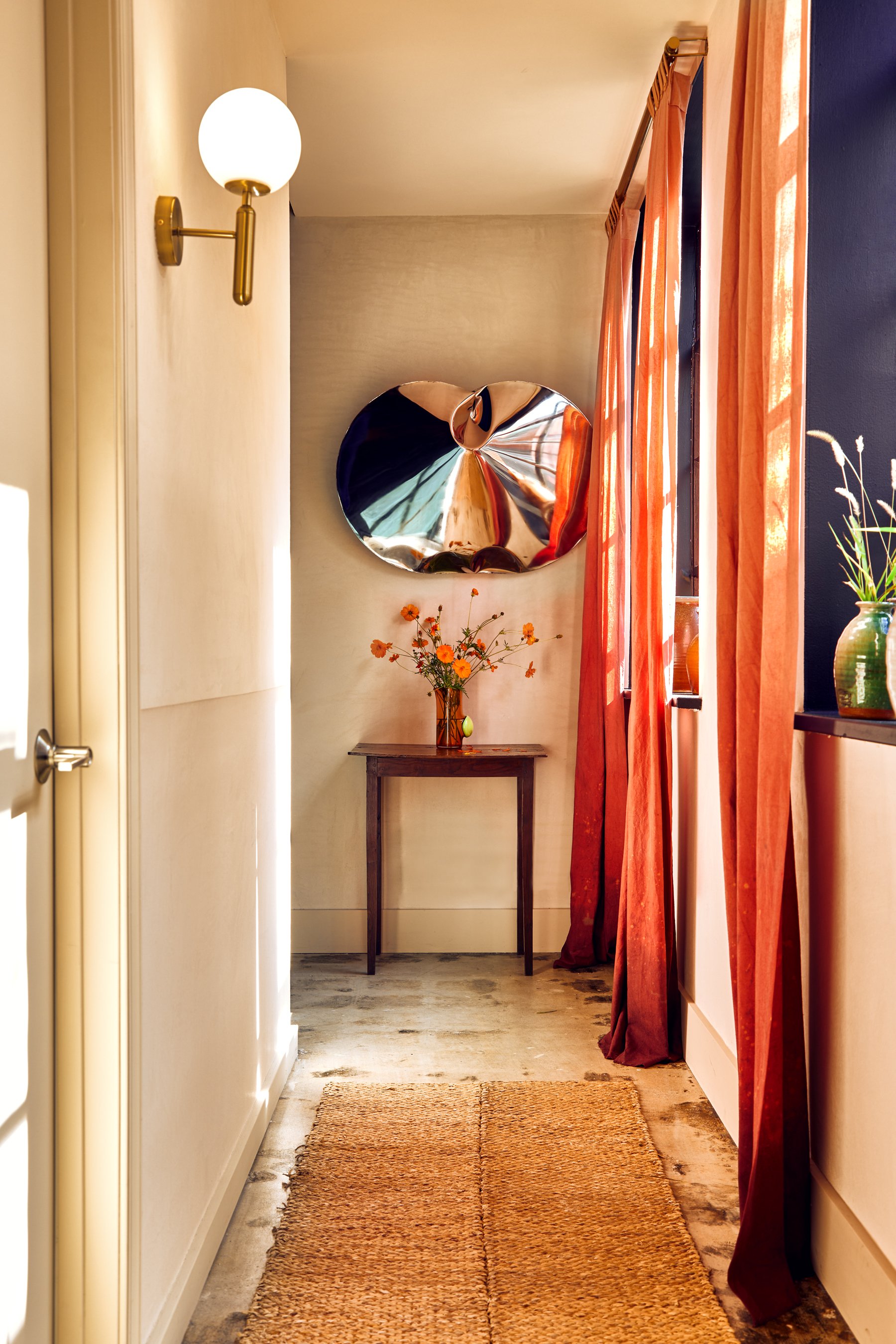 Inflated stainless mirror. Two-color Marmorino plaster walls. Custom dip dyed draperies.