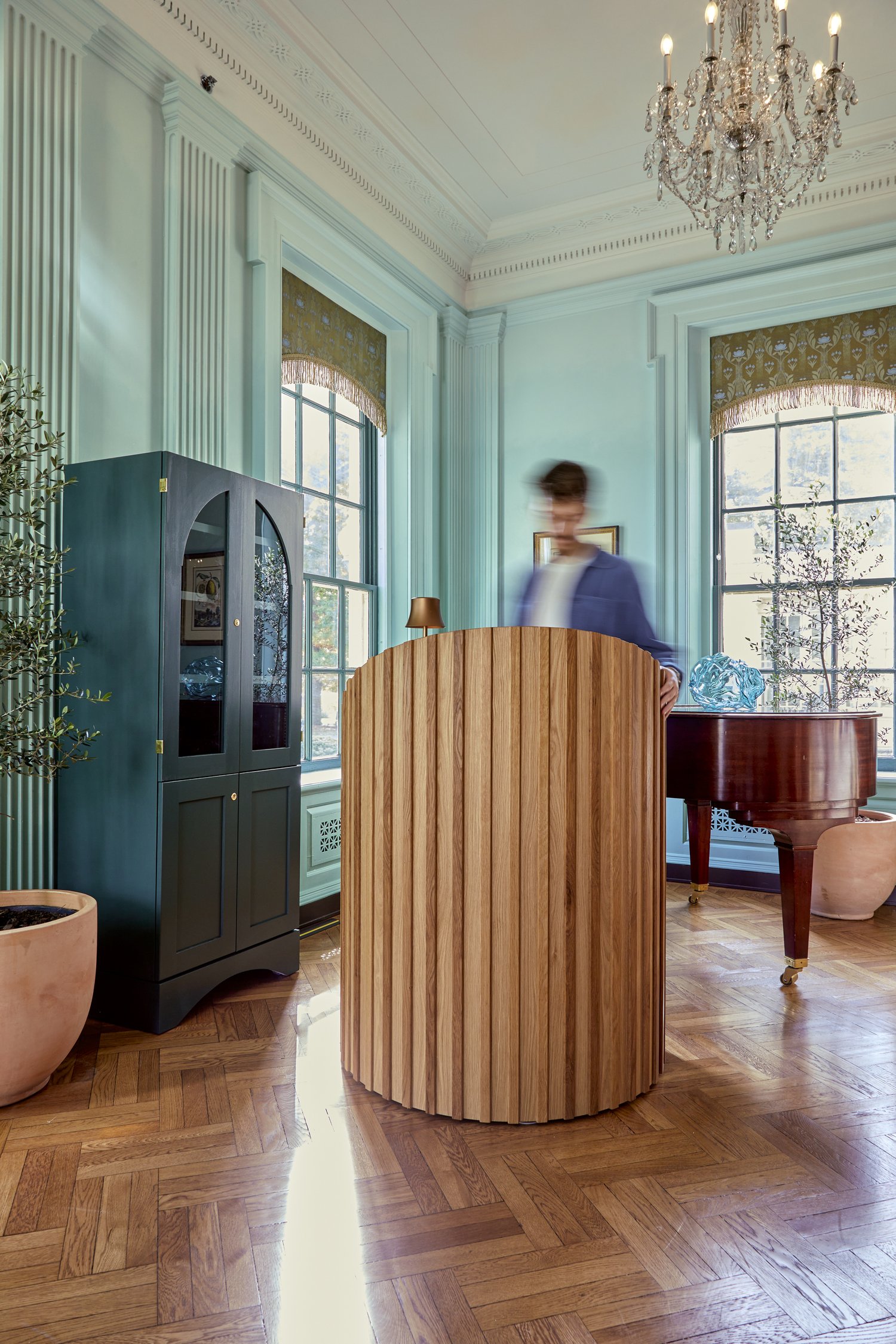 Mobile retail unit. Half moon white oak host stand. Silk valances.