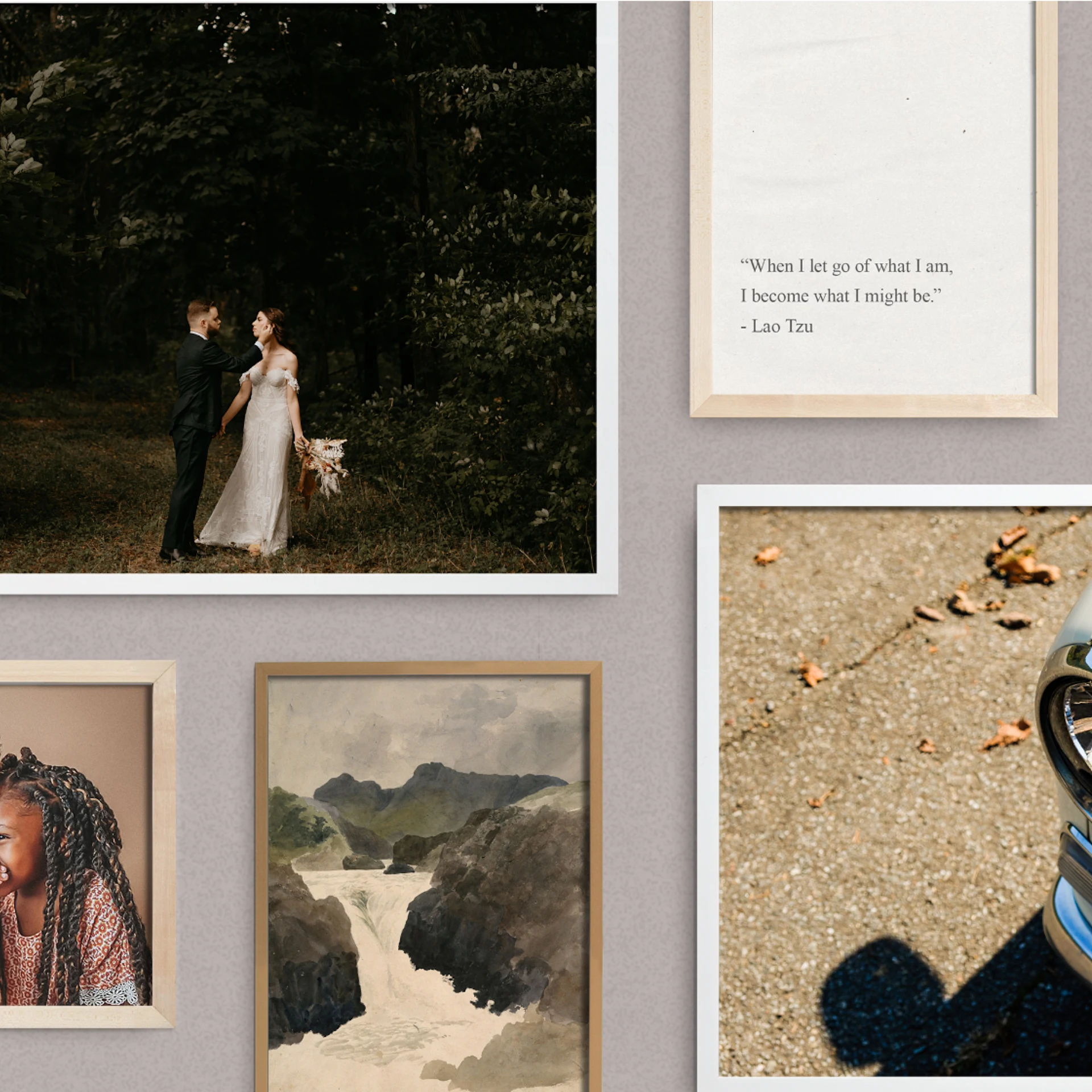A gallery wall of framed photographs in different sizes and orientations.