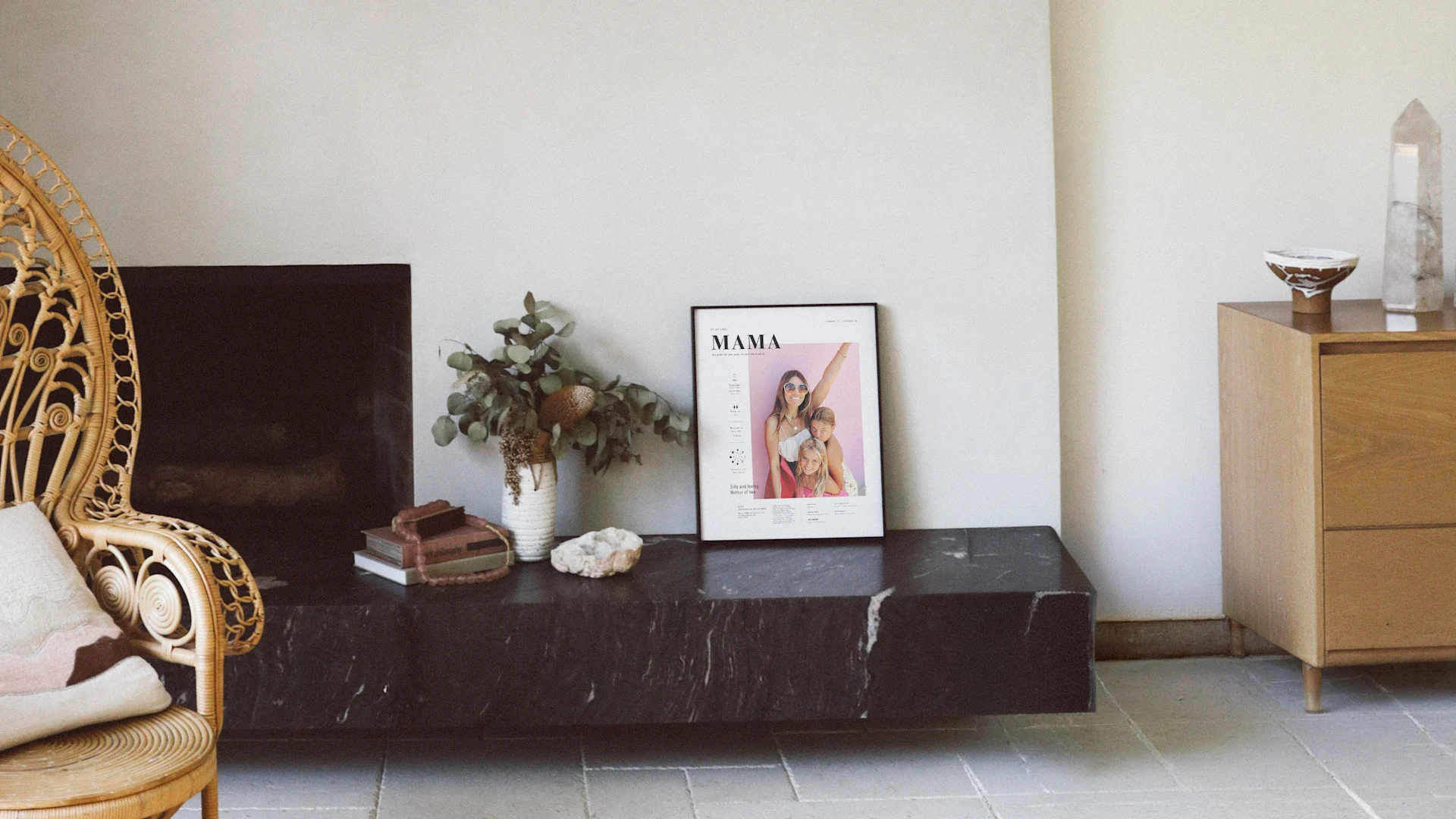 Personalized Mom Art Print from Still Novel in a black frame displayed on a dark marble console alongside dried flowers and decorative accents in a warm, minimalist living room.