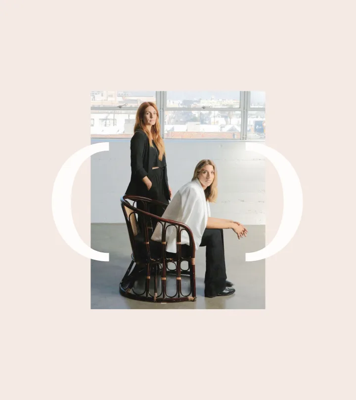Still Novel’s two founders pose beside a studio window.