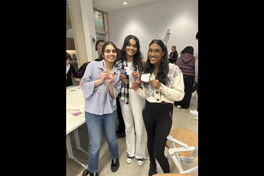 Members hold up some cards made during the event.