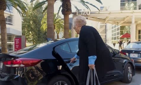 AARP image of an elderly woman getting in a car