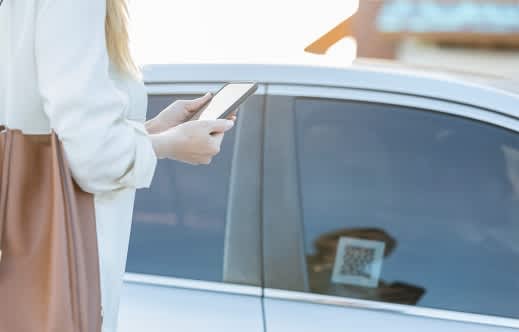 Person unlocking a car with a cell phone