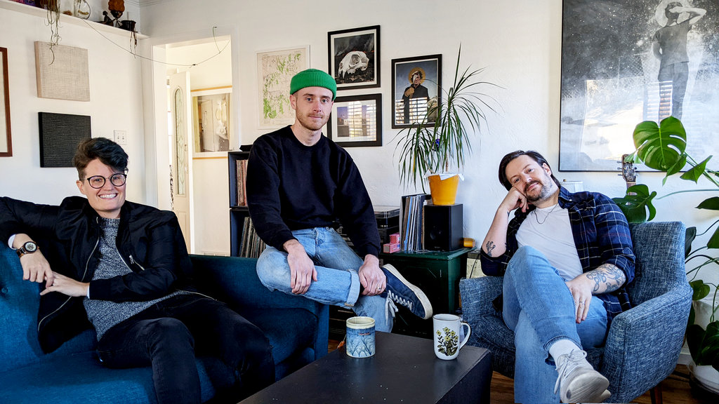 J, Clint, and Daniel sitting in a room enjoying a tea