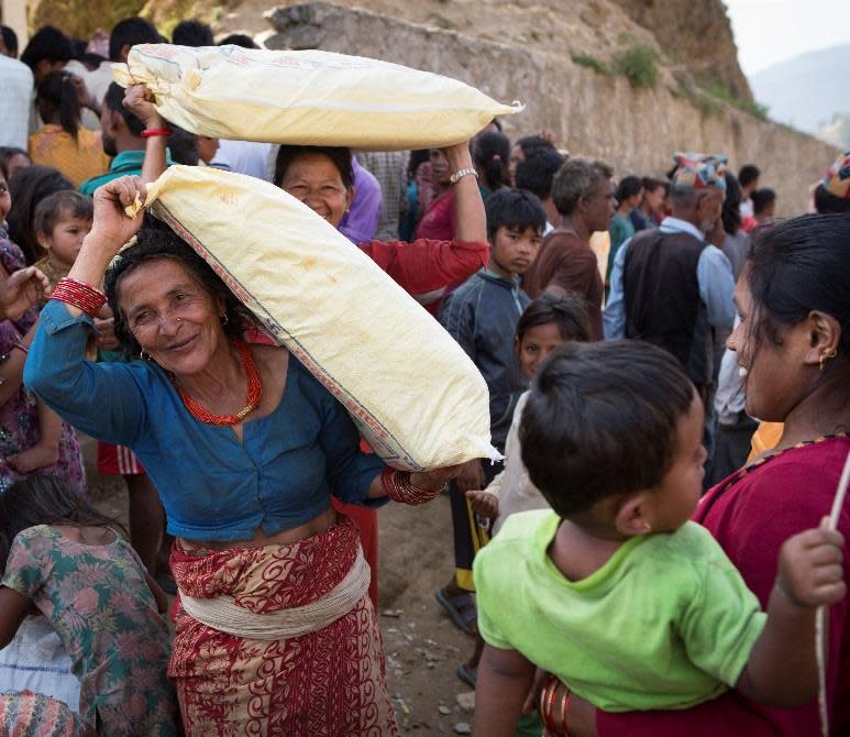 Women carrying shelter kits in Nepal.
