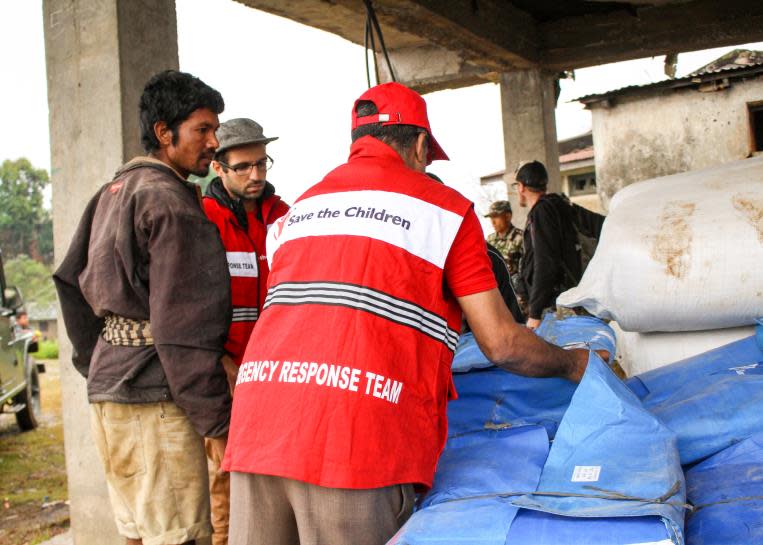 The Save the Children emergency response team unloading supplies in Nepal.