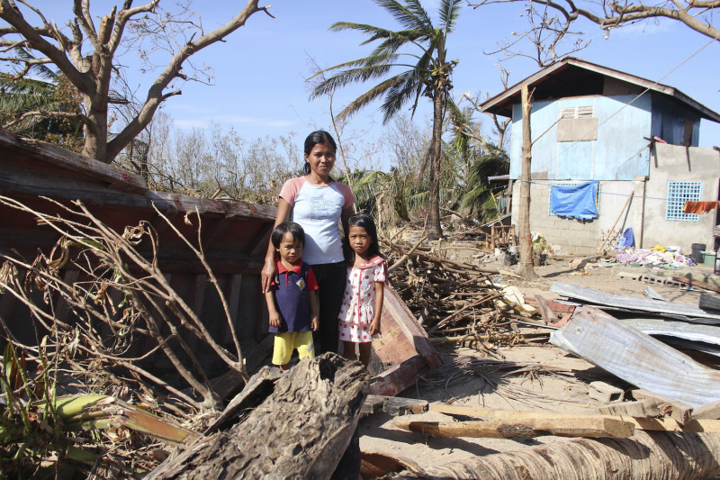 A family amidst devastation from Typhoon Haiyan.