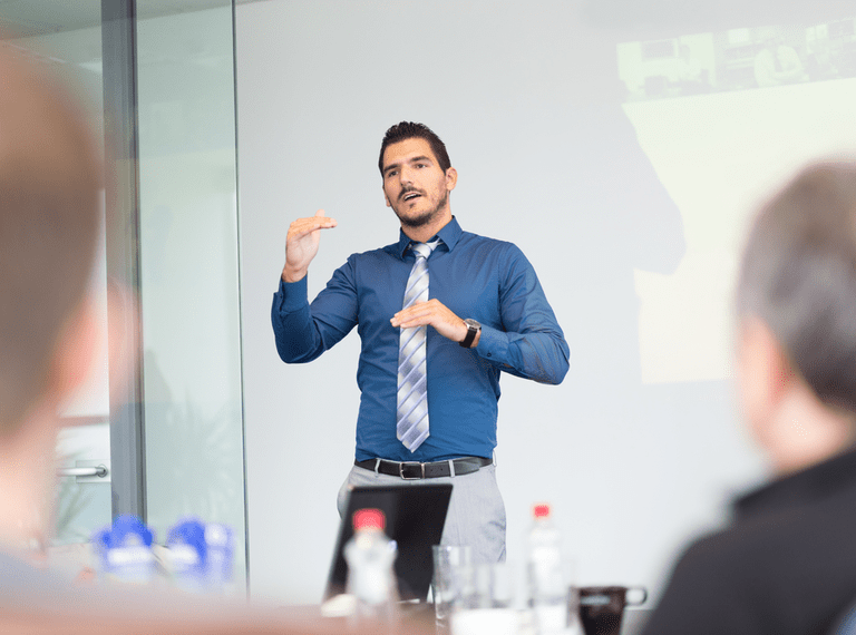 A man confidently gives an interview presentation