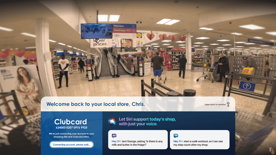 Augmented reality interface inside a Tesco store viewed through Apple Vision Pro AR glasses, featuring a personal welcome message, Clubcard connection screen, and voice-activated Siri assistance for shopping and starting a workout for step counting.