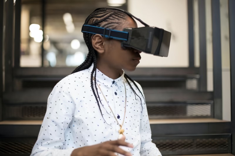 A girl wearing VR goggles [Article Image]
