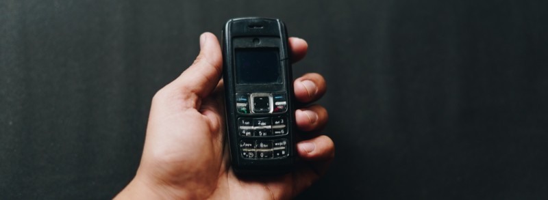 Image of hand holding an old phone