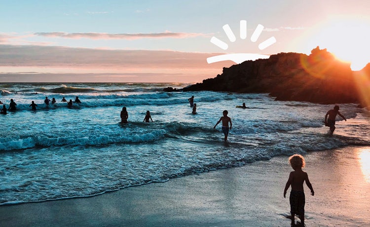 Skyscanner ad with image of the beach and people in the ocean