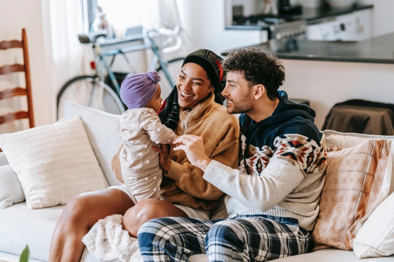 Image of a family with a baby on the couch