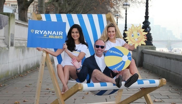 Photo of three people on a huge chair with Ryanair signs