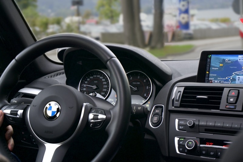 Photo of a BMW car's steering wheel and dashboard