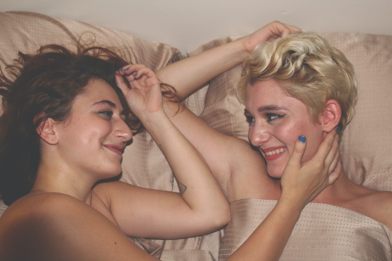 Image of two women in bed smiling [Article Image]