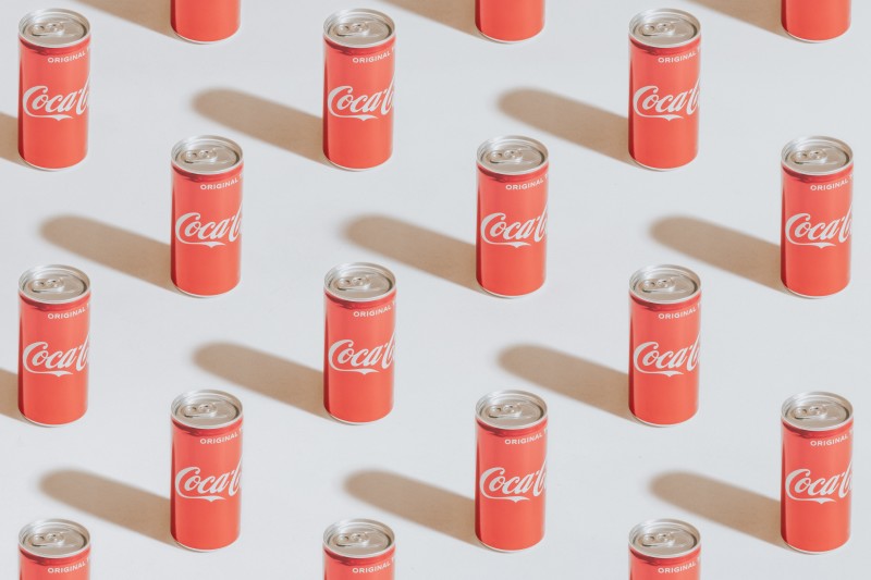 Photo of many Coca-Cola cans lined up [Article Image]