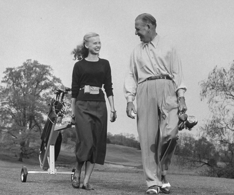 Image of a man and woman with golfing attire