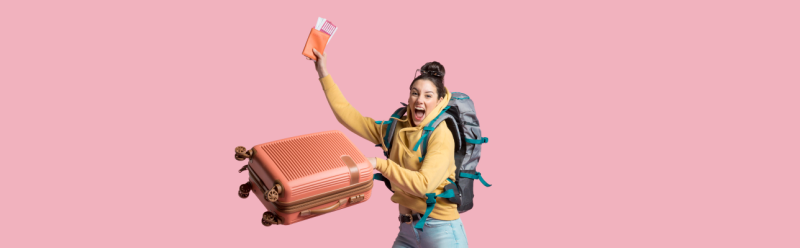 Photo of women jumping with luggage