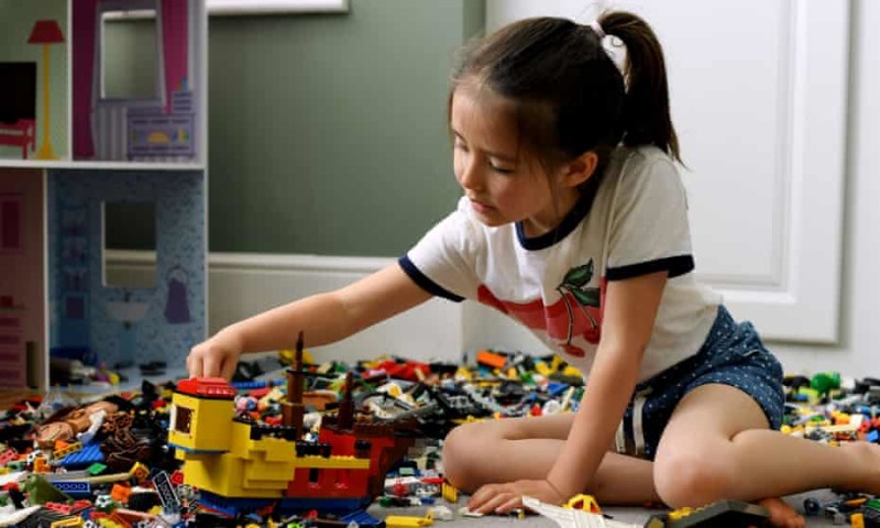 A little girl playing Legos