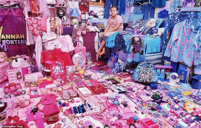 Image of a girl sitting in a room with blue and pink toys