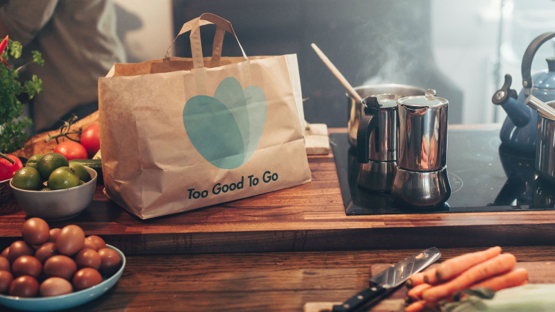 Photo of Too Good To Go bag next to a stove top