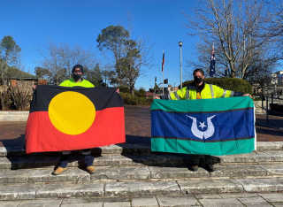 Photo: Council’s Ed Hunter and Craig Martin with Aboriginal and Torres Strait Island flags.