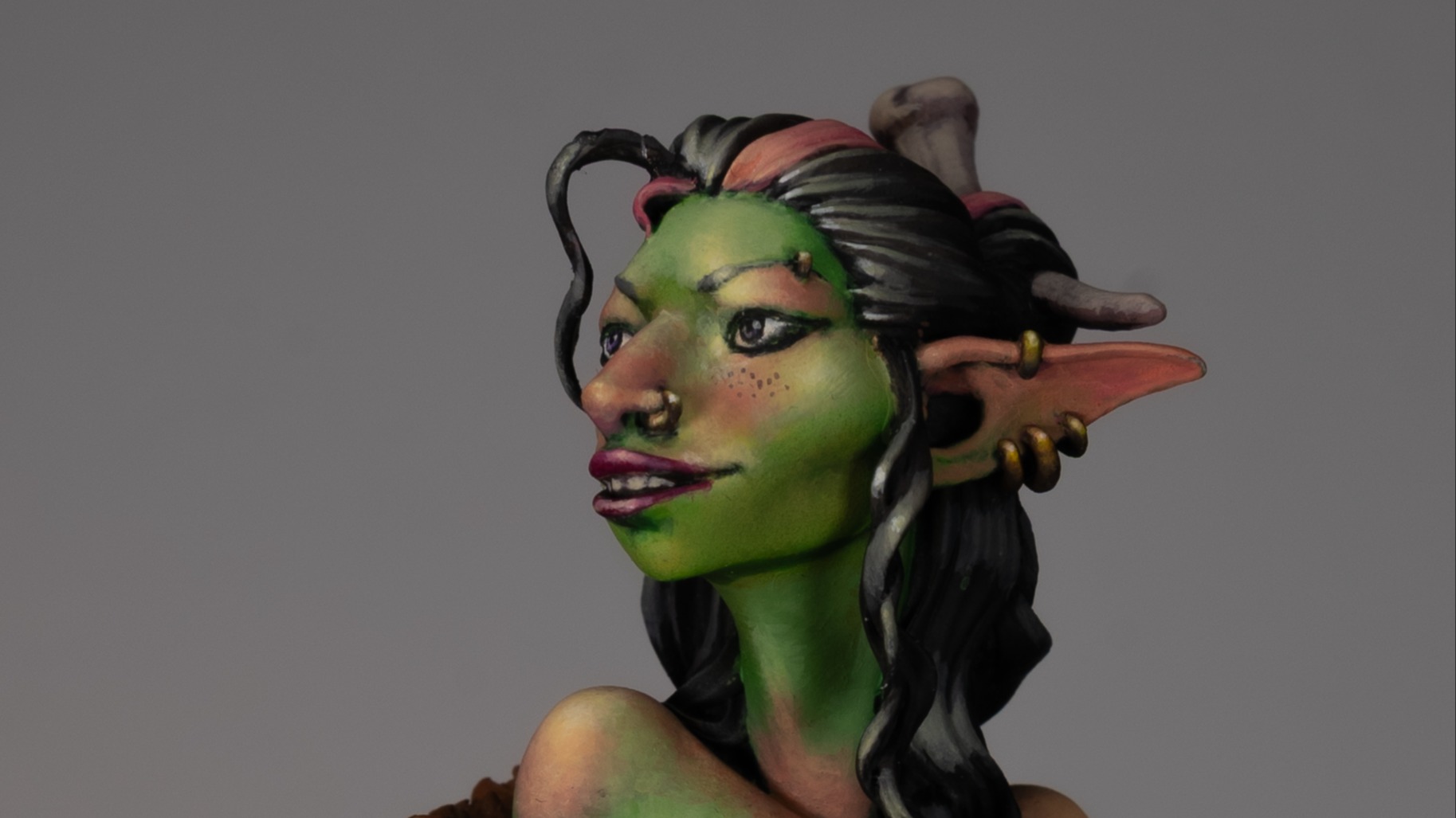 Cropped side view of a female goblin bust