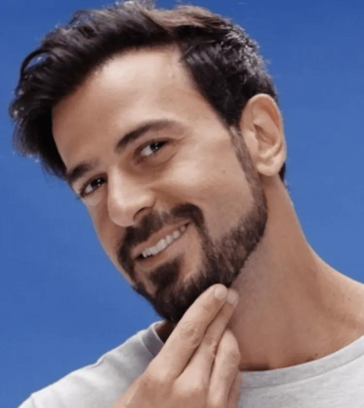 A Man Shaping Up His Beard Neckline