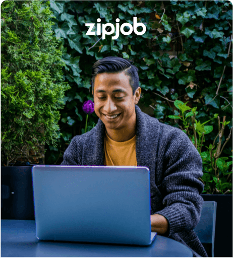 Person working on laptop outside. ZipJob Branded.