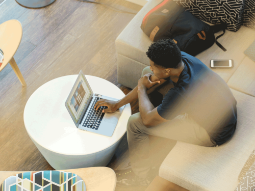 Man on laptop in coffee shop LinkedIn sales solutions