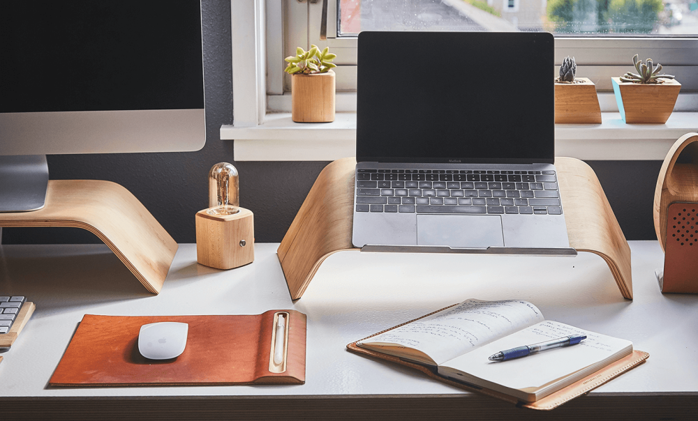 Desk with a laptop, monitor & notebook