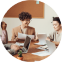 Team of people working in a meeting room in a circle
