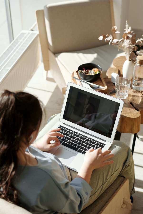 Woman typing on open laptop