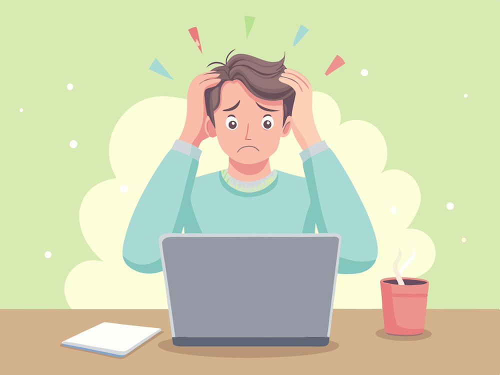 Man stressed behind laptop