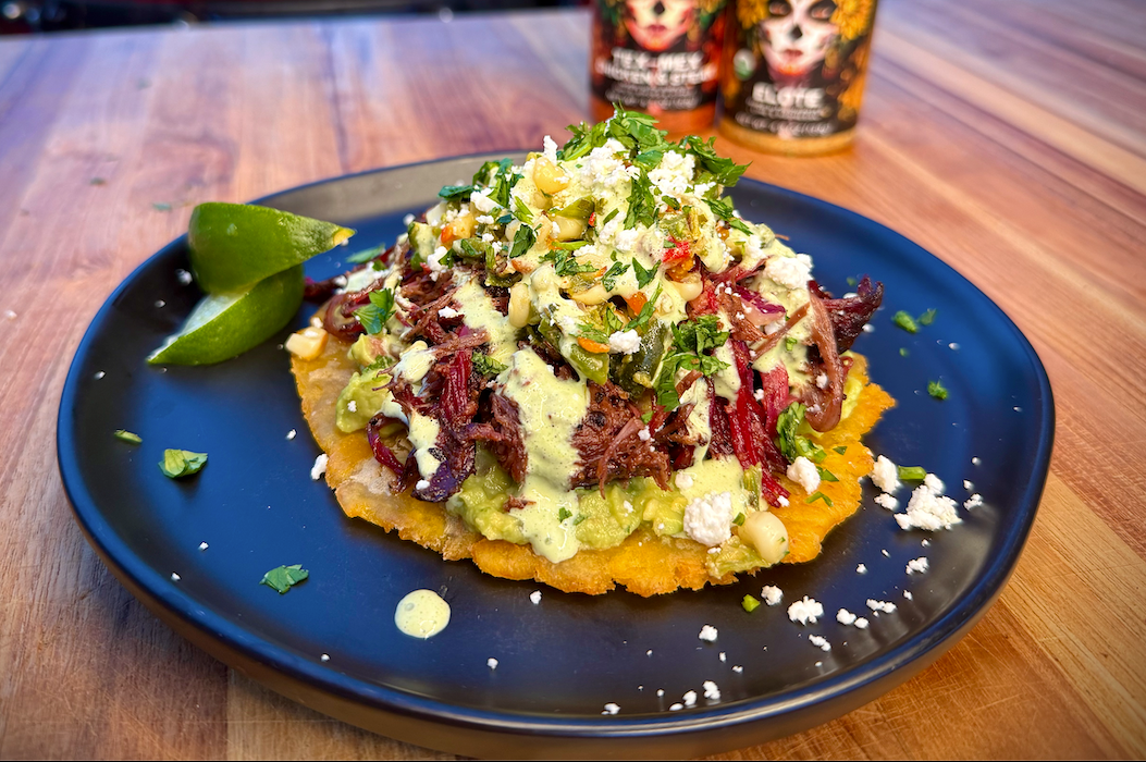 Smoked dino rib tostones with elote + poblano crema