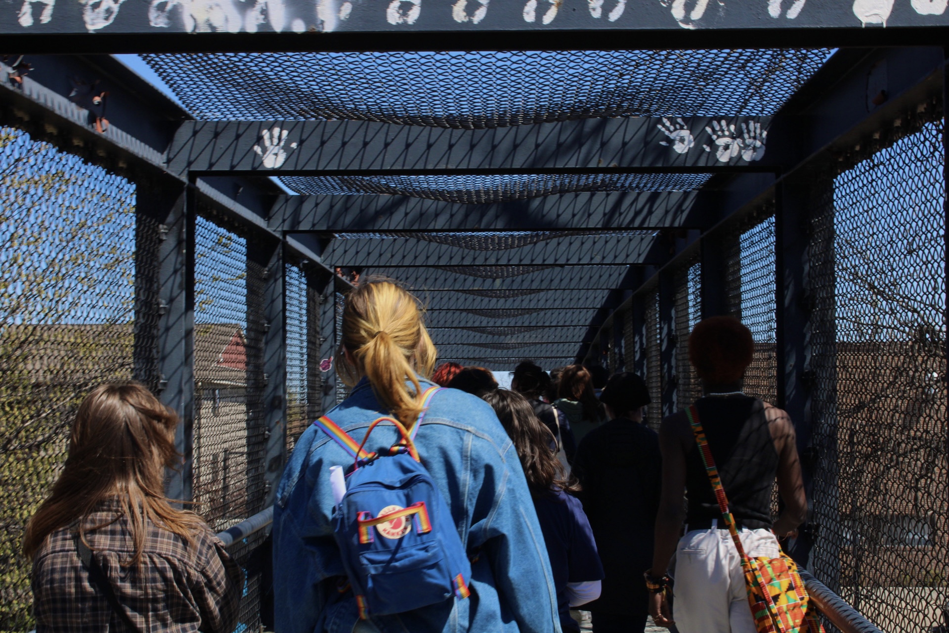 Students walking across the Van Cleve bridge the memory walk.