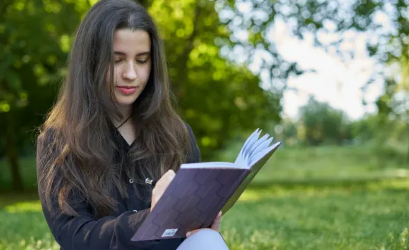 Girl writing in a book