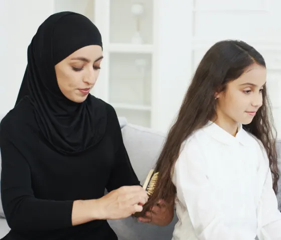 Mom Brushing Daughter's Hair