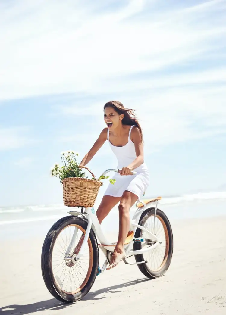 Girl Cycling on Beach