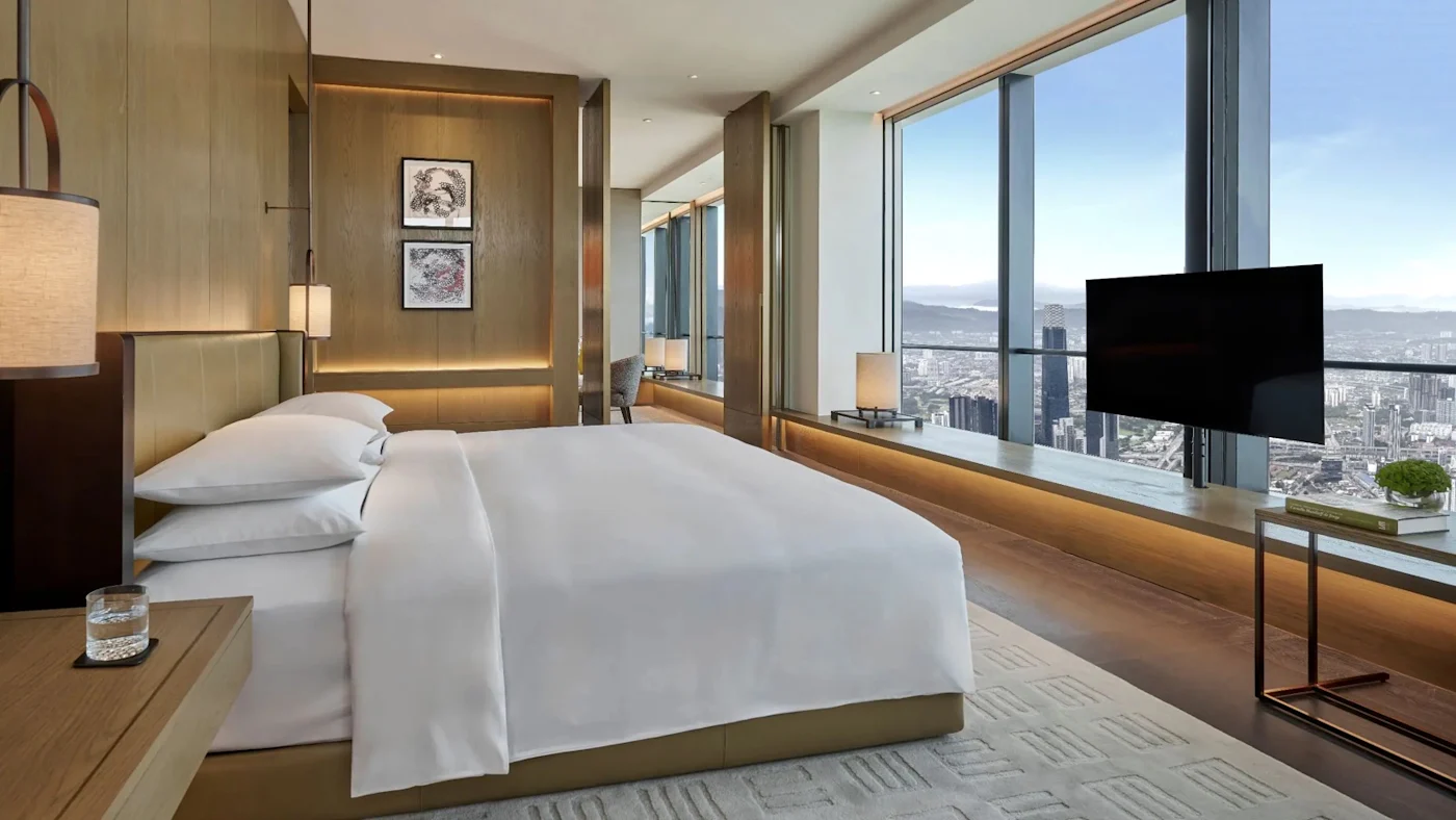 A high-floor guestroom in Merdeka 118, with floor-to-ceiling glass over the Kuala Lumpur skyline.